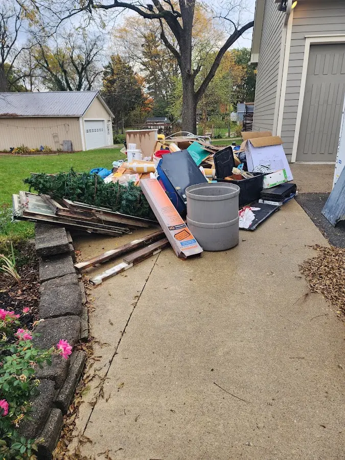 Dumpster being loaded with debris for Commercial Dumpster Rental in Malden